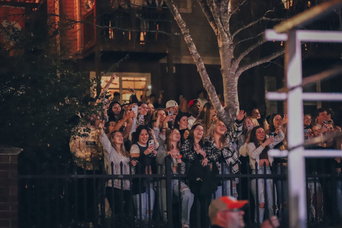 More fans stood against a fence behind the stage to cheer on the performers.