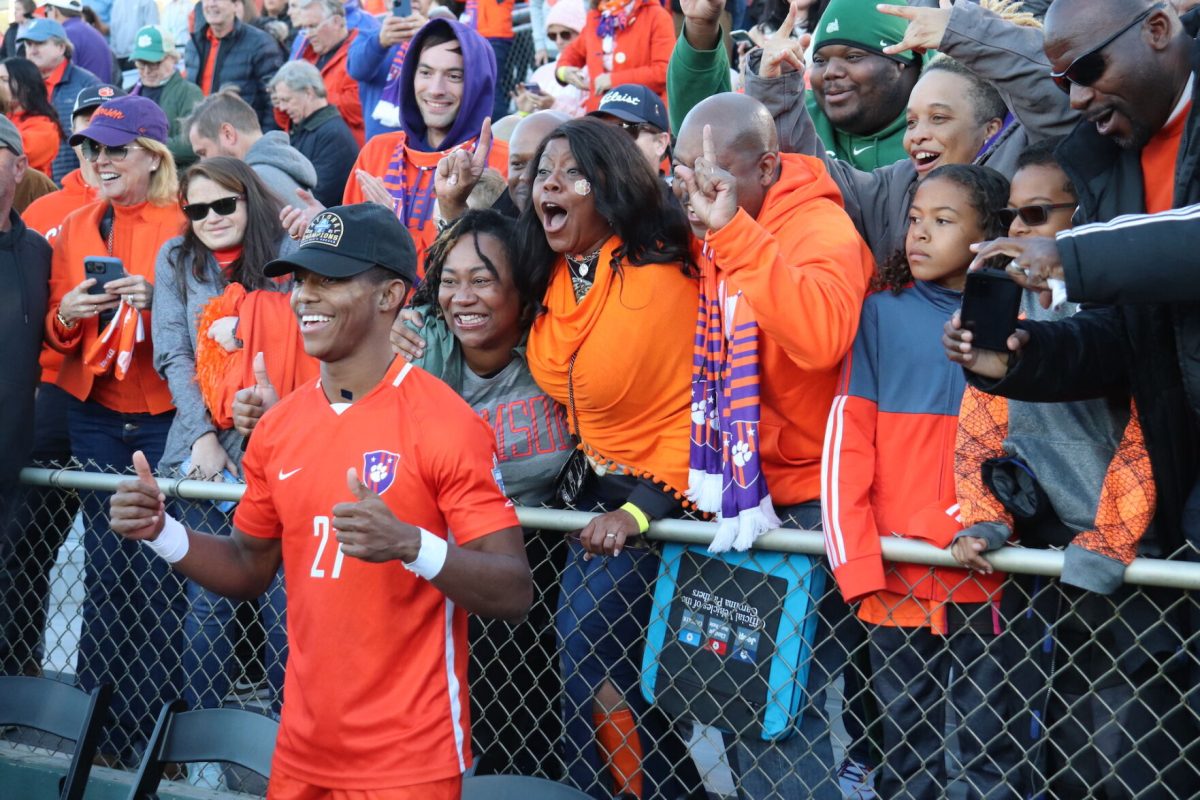 Clemson+mens+soccer+defender+Isaiah+Reid+celebrates+with+fans+after+winning+the+2021+National+Championship.