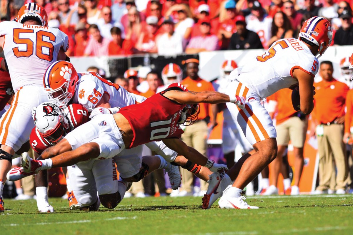 NC State junior safety Tanner Ingle (10) goes to tackle Clemson quarterback DJ Uiagalelei (5) in the game on Saturday, Sept. 25, 2021 in Carter-Finley Stadium. The Wolfpack beat the Tigers in overtime 27-21. Ingle had a total of 7 tackles.