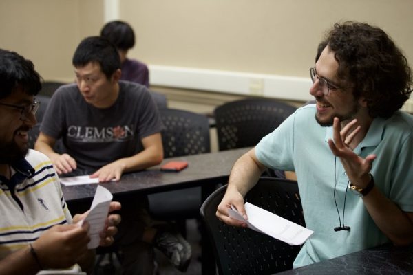 Students work through an activity to practice their English with one another.