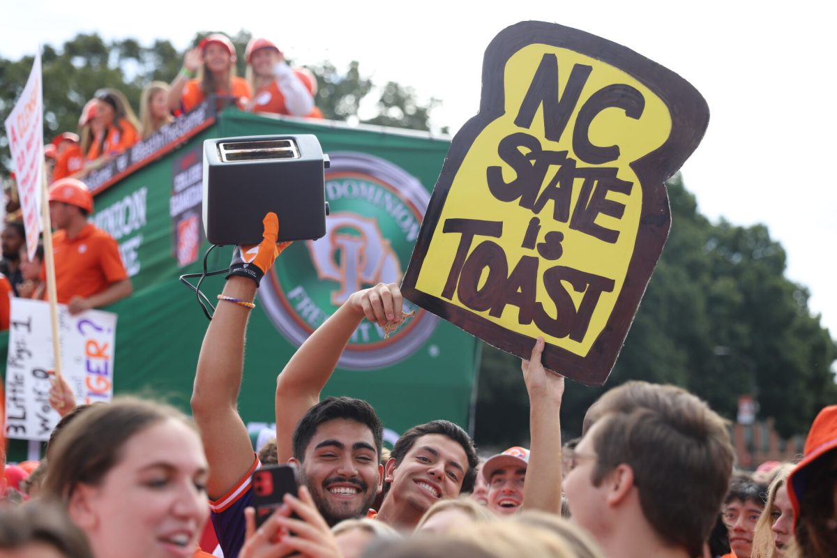 Two Clemson fans hold up a sing and a toaster during College GameDays appearance at Clemson on Oct. 1, 2022. 