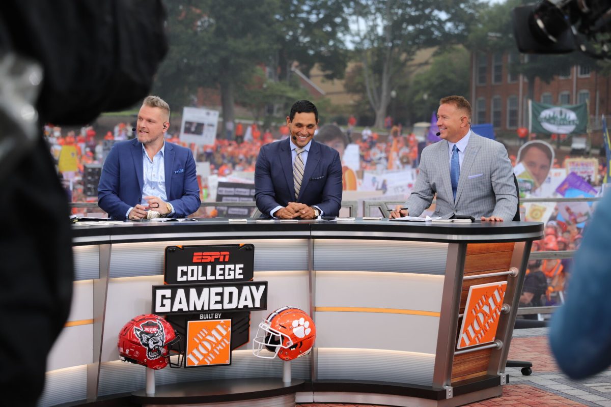 College GameDay hosts Pat McAfee (left), David Pollack (middle) and Kirk Herbstreit (left) sit at the desk during College GameDays visit to Clemson on Oct. 1, 2022. 