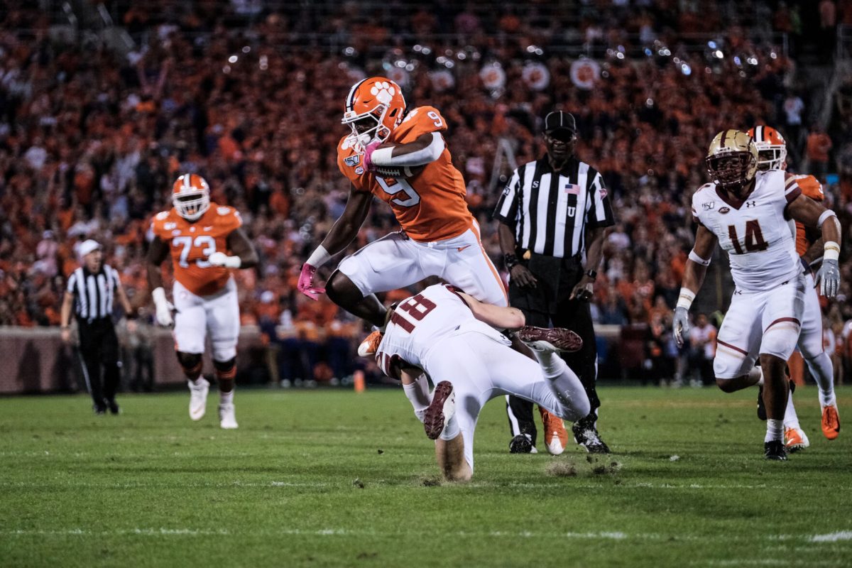 Clemson running back Travis Etienne (9) is taken down by Boston College's Mike Palmer (18) in a matchup against Boston College on Oct. 26, 2019 at Memorial Stadium.