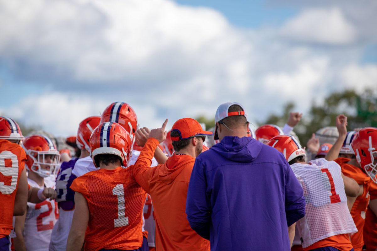Players assemble around head coach Dabo Swinney, chanting T-I-G-E-R-S, during practice in Miami on Dec. 28, 2022 before the Orange Bowl.
