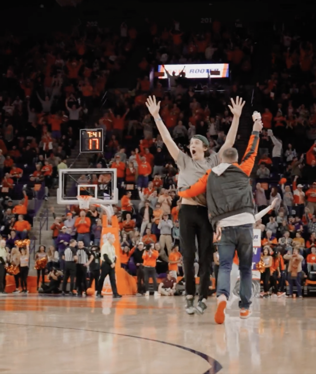 Kevin Murphy, a freshman computer science major, celebrates on the court of Littlejohn Coliseum after making a golf putt to win $10,000. 
