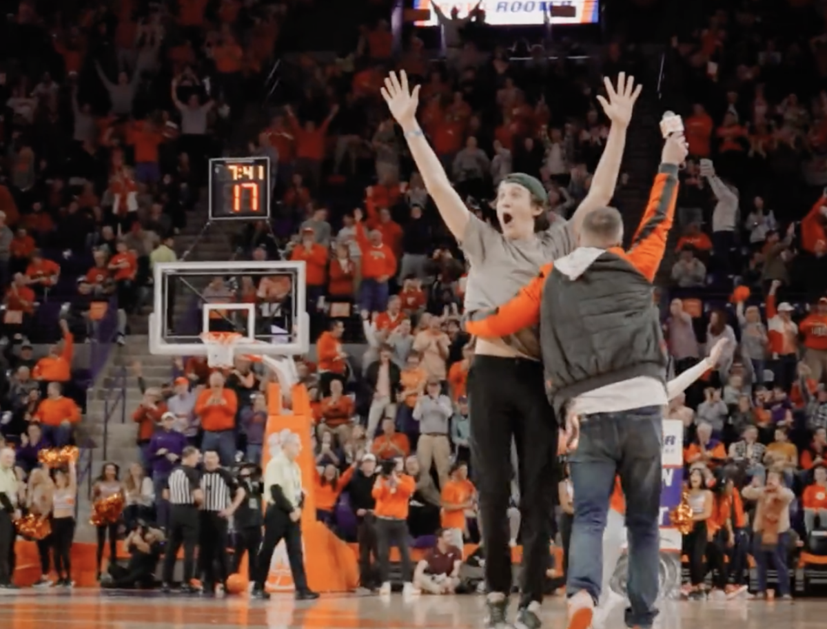 Kevin Murphy, a freshman computer science major, celebrates on the court of Littlejohn Coliseum after making a golf putt to win $10,000. 