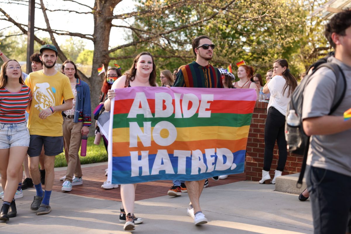 Students+holding+a+flag+reading+abide+no+hatred