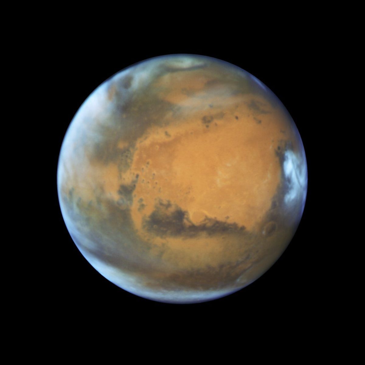 This image shows our neighbouring planet Mars, as it was observed shortly before opposition in 2016 by the NASA/ESA Hubble Space Telescope. Some prominent features of the planet are clearly visible: the ancient and inactive shield volcano Syrtis Major; the bright and oval Hellas Planitia basin; the heavily eroded Arabia Terra in the centre of the image; the dark features of Sinus Sabaeous and Sinus Meridiani along the equator; and the small southern polar cap.