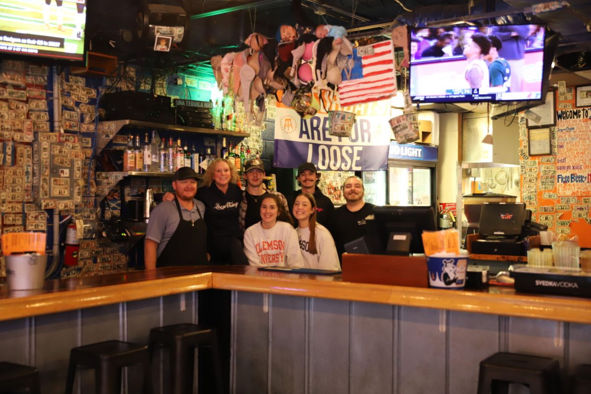 The Fullers, owners of Loose Change & Evolve, and the staff of Loose Change behind the bar. The bras, burgers and beer make Loose Change one of Clemsons favorite spots for a bite to eat or drink.