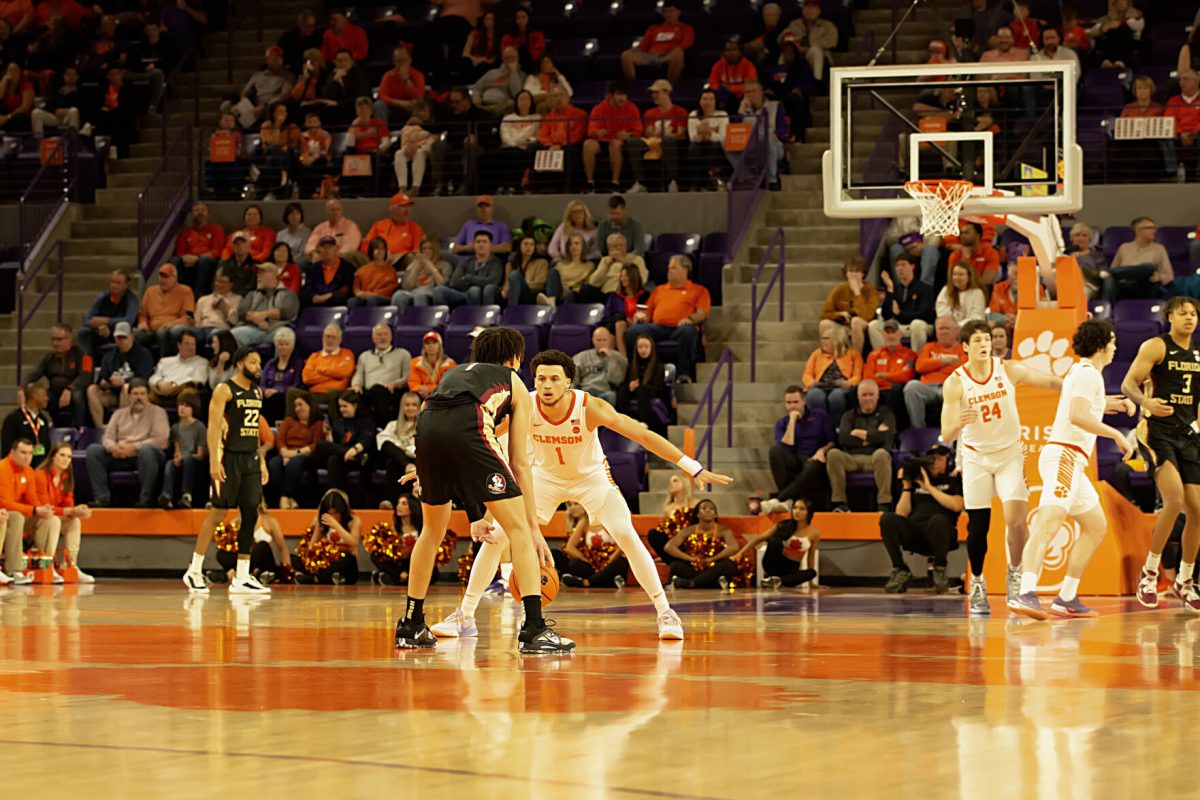 Clemson guard Chase Hunter (1) defends a Florida State player as teammate PJ Hall (24) moves behind him. 