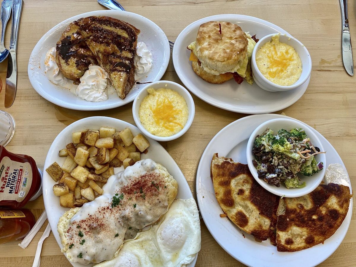 A hearty breakfast spread from SunnySide Cafe, featuring Strawberry Cream Cheese Stuffed French Toast, the Fried Green Tomato, Egg, Cheddar & Bacon Biscuit, a Pimento Cheese & Bacon Quesadilla, Biscuits & Sausage Gravy and of course cheese grits. 