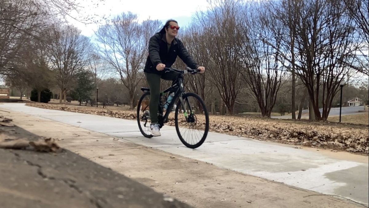 Asst. News Editor Corey Glenn tries out the new bike path through Gateway Park, a part of Phase I of the Green Crescent Trail.