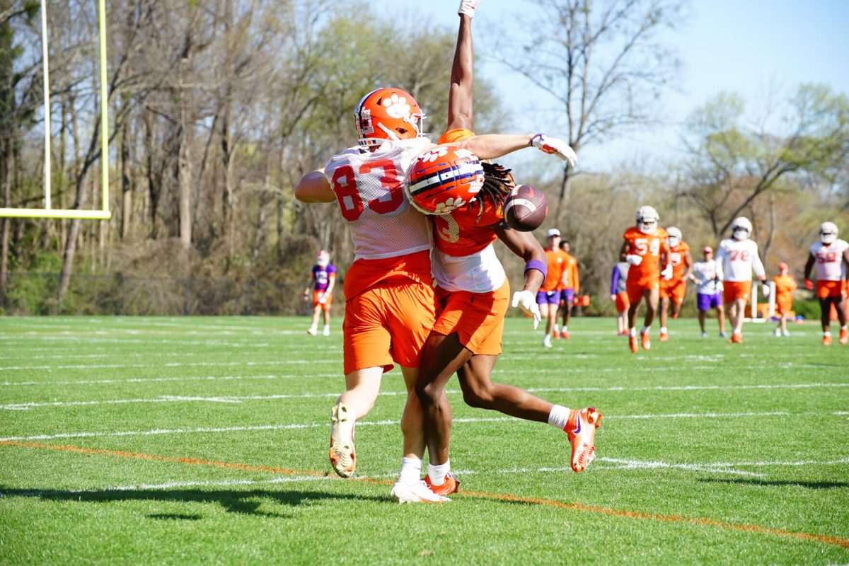Clemson+wide+receiver+Hampton+Earle+%2883%29+attempts+to+catch+a+pass+while+getting+hit+by+cornerback+Toriano+Pride+Jr.+during+practice+on+March+7%2C+2023.