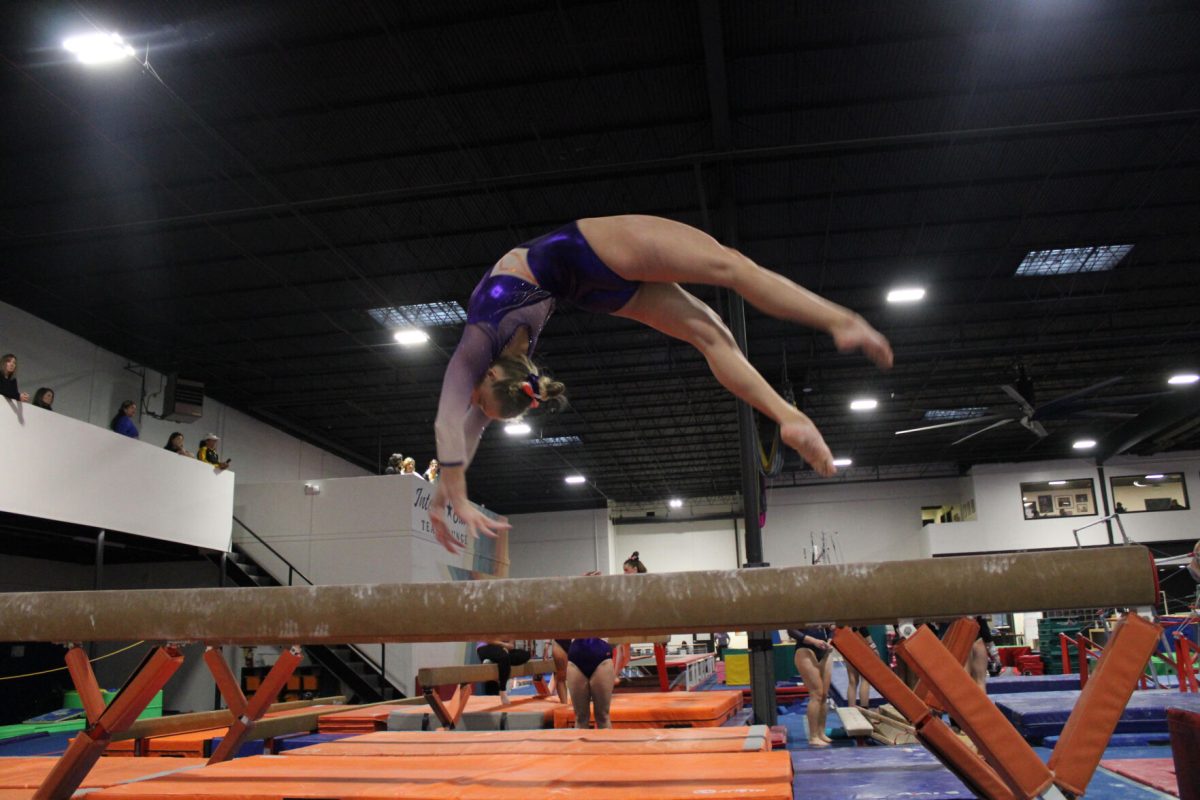 Grossman lands a trick on the beam at practice. 