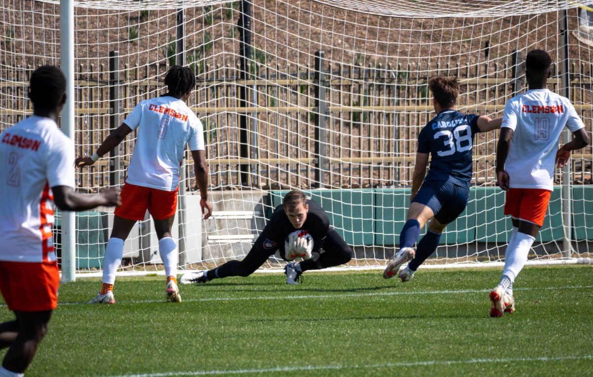 Former Clemson goalie and 2021 National Champion George Marks saves a potential goal from UNC during a scrimmage in March 2022.