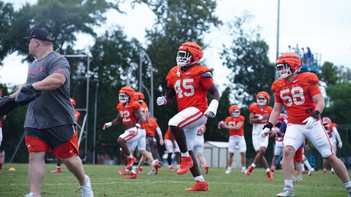 Clemson defensive tackle Vic Burley (45) warms up before practice on Aug. 10, 2023.