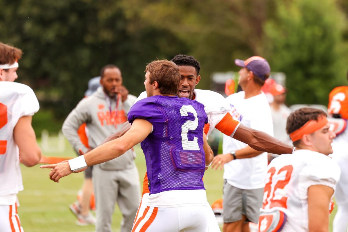 Clemson quarterback Cade Klubnik and wide receiver Beaux Collins talk with each other during practice on Aug. 10, 2023.