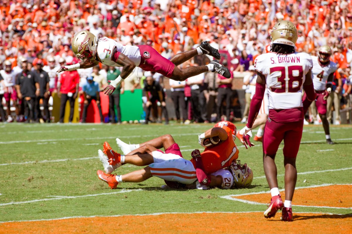 Clemson running back Will Shipley sends a Florida State defender flying overhead in the end zone. 