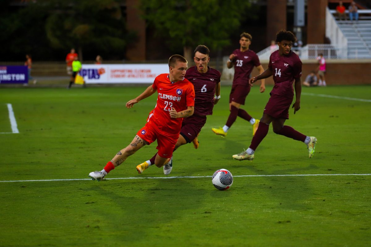 Midfielder Jackson Wrobel weaves the ball through a line of Virginia Tech players. 