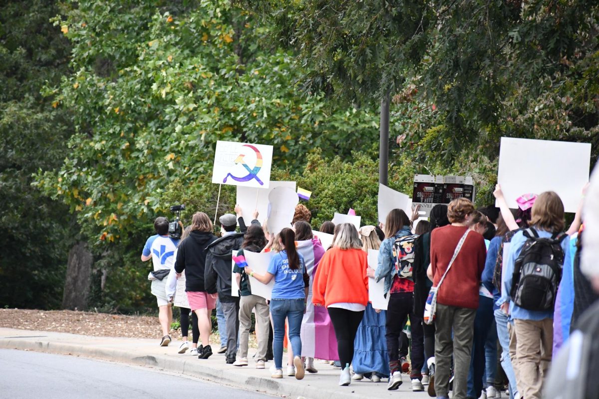 As they marched, the students chanted, “We’re here, we’re queer, we won’t disappear,” and held aloft a sea of rainbow flags along with a variety of signs with LGBTQ and communism symbols. 