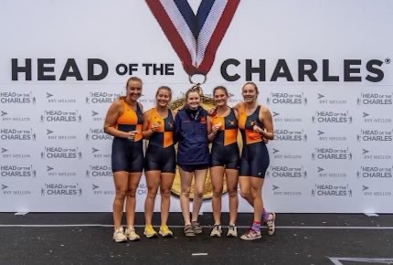 The varsity womens team poses with their bronze medals after the Head of the Charles Regatta.