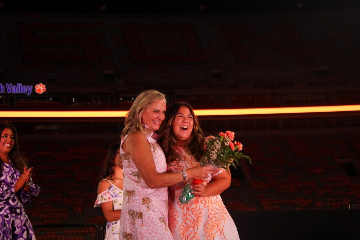 Beth Clements celebrates the runner-ups to the Miss Homecoming competition.