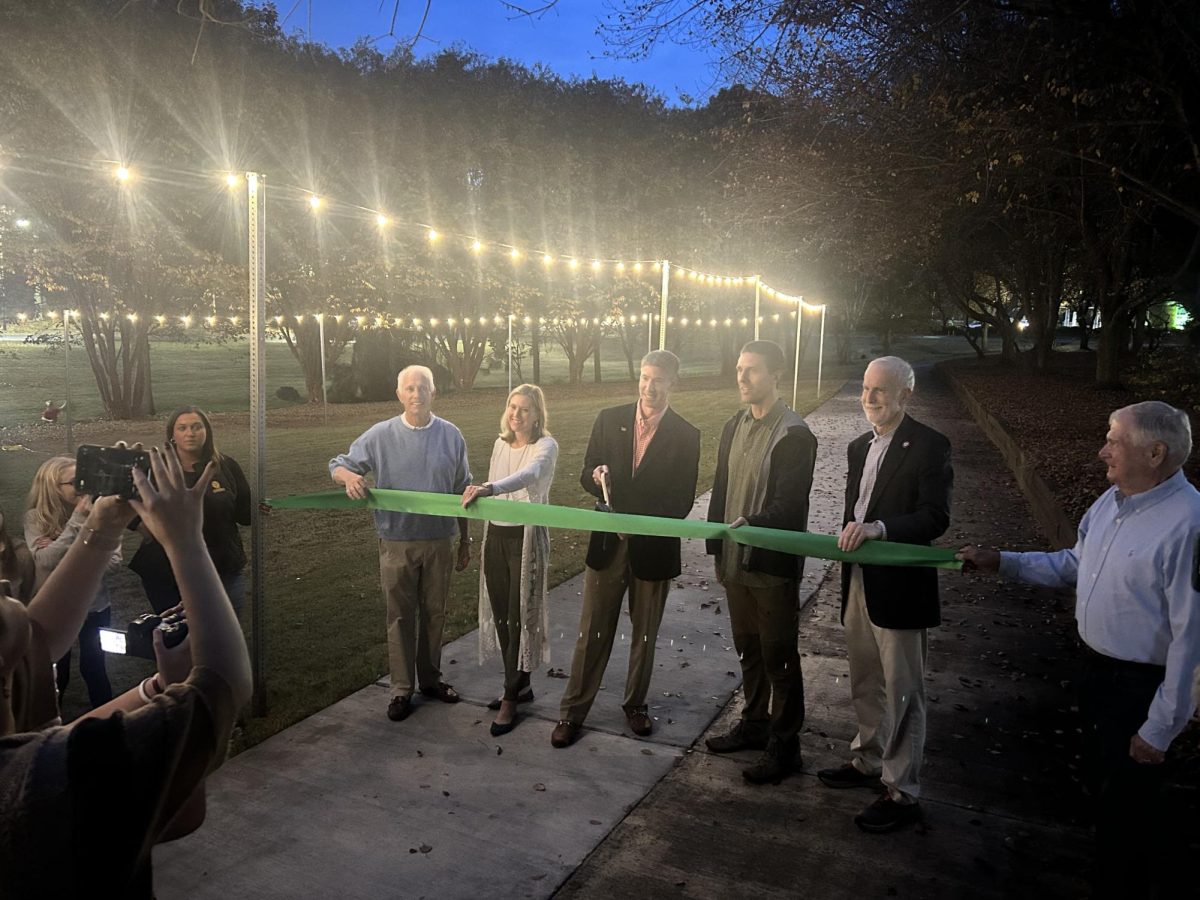 Clemson+mayor+Robert+Halfacre+helps+cut+the+ribbon+at+the+opening+of+the+Green+Crescent+Trail.