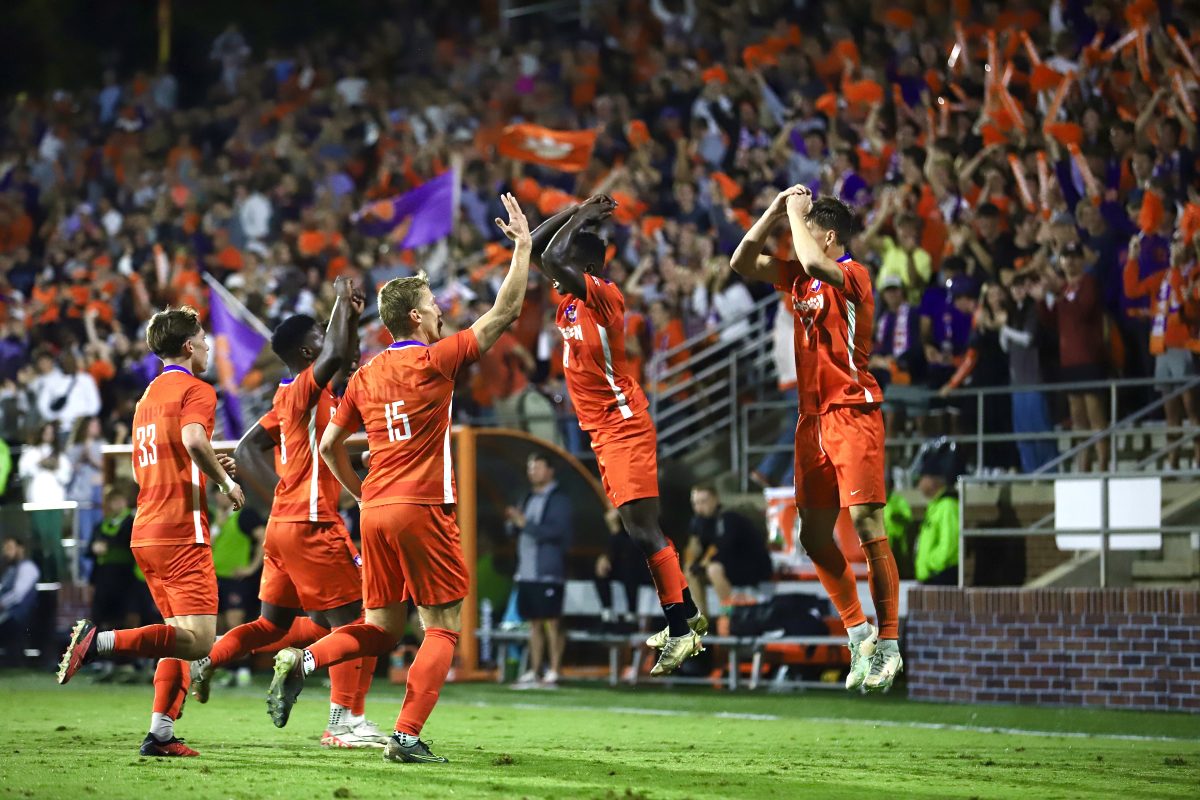 Ousmane Sylla (10) and the team jump in celebration after the Tigers surged to a 3-1 lead in the first half against Louisville.