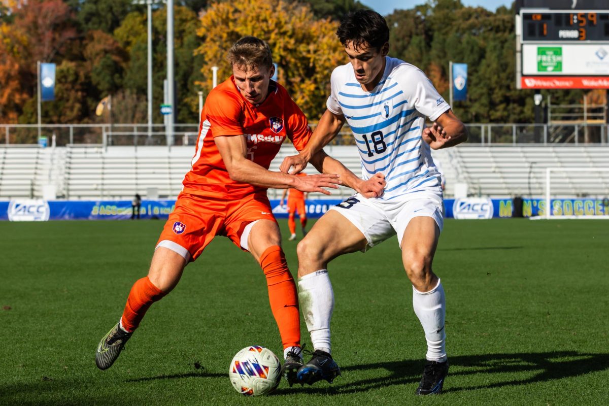 Clemson forward Alex Meinhard holds off a UNC defender at the ACC Championship in Cary, North Carolina, on Sunday, Nov. 12.