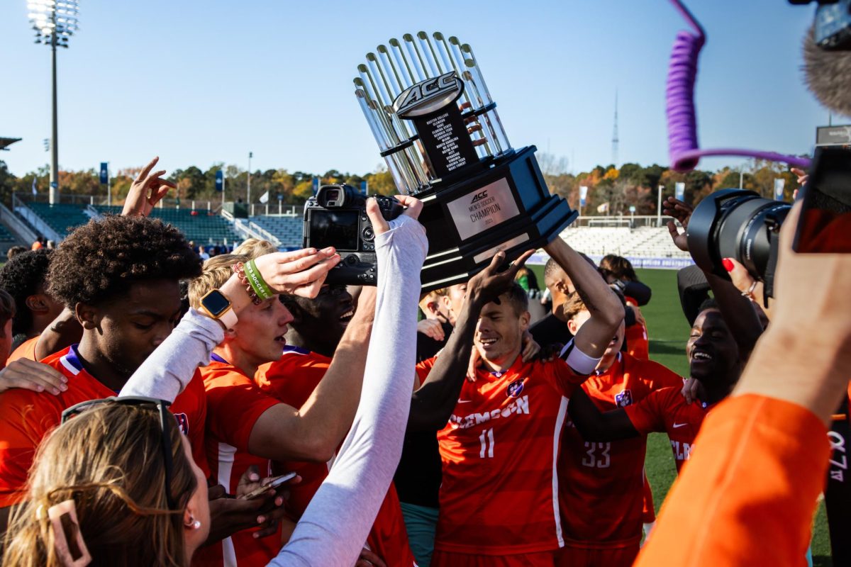 The Clemson mens soccer team poses with the ACC Championship trophy after defeating North Carolina in penalty kicks in Cary, North Carolina, on Nov. 12, 2023.