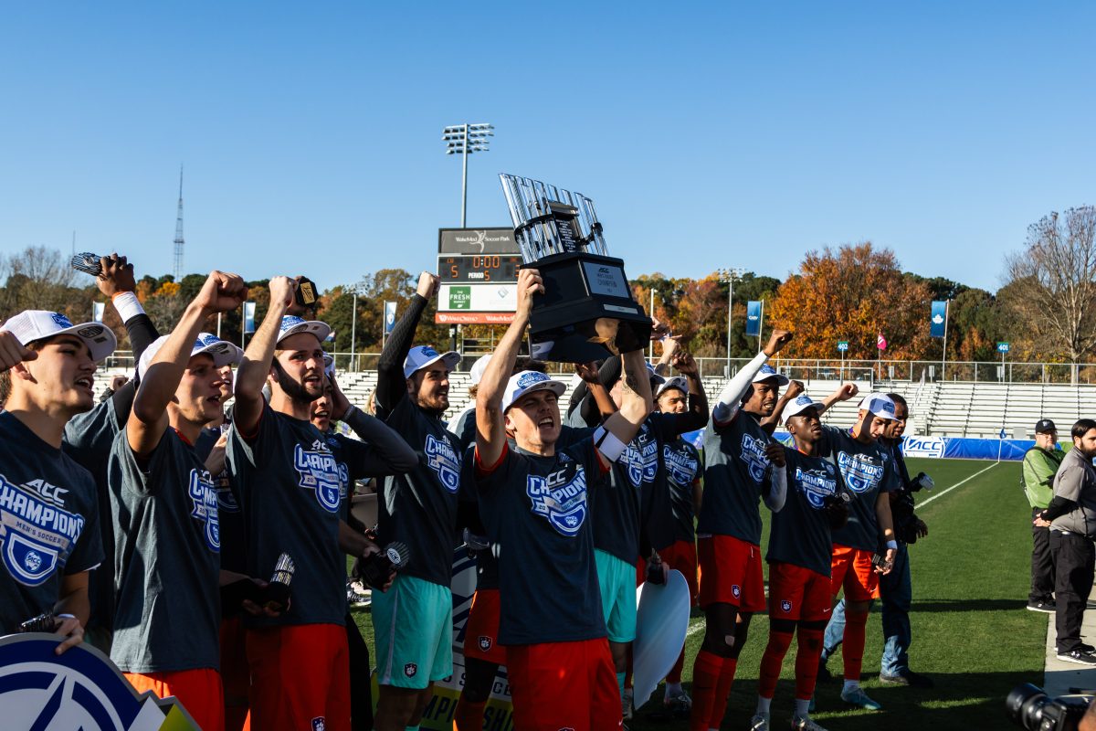 The Tigers are bringing home the ACC Championship trophy for the first time since 2020; pictured is senior midfielder Brandon Parrish hoisting it over his head as the team celebrates.