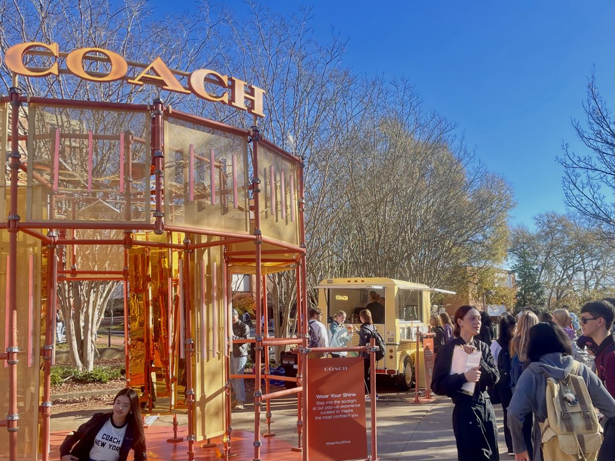 Coach offers students a complimentary coffee beside its pop-up purse shop.