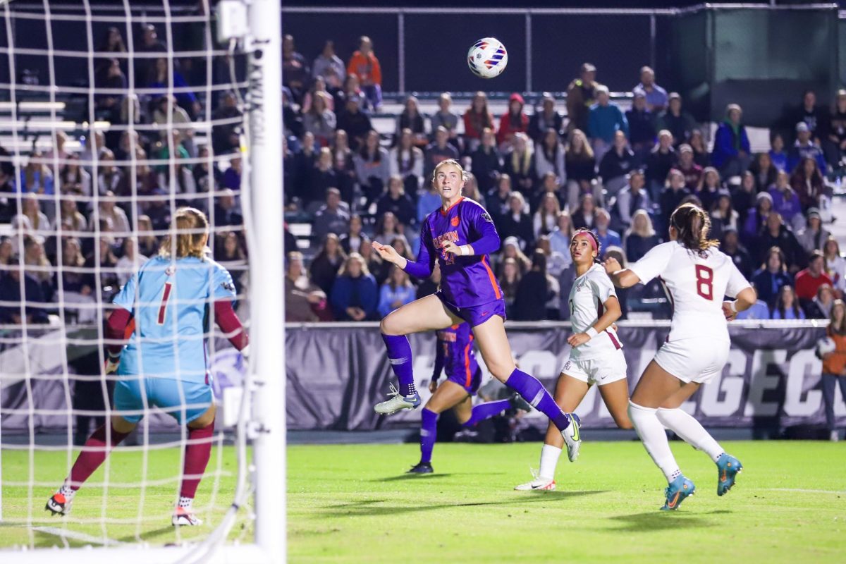 Clemsons Megan Bornkamp jumps up to find the ball near the net in the Tigers match against Florida State in the College Cup semifinals in Cary, North Carolina, on Dec. 1, 2023.