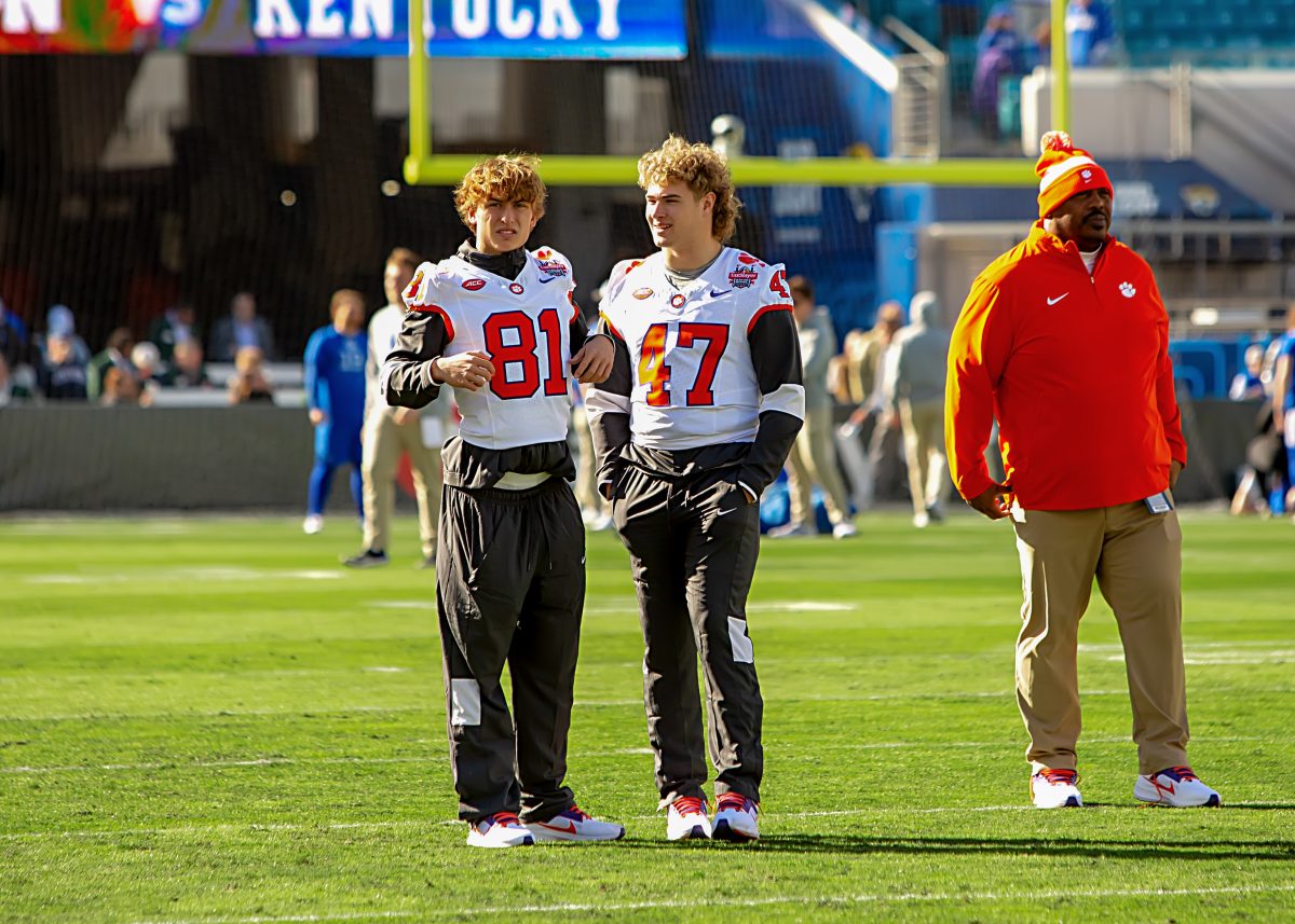 Mid-year enrollees Nolan Hauser (81) and Sammy Brown (47) talk on the field ahead of the Gator Bowl on Dec. 29, 2023.
