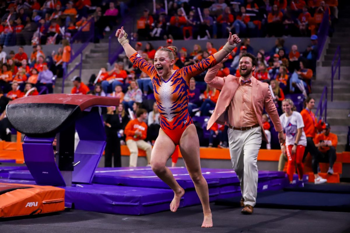 Lilly Lippeatt celebrates after her vault during the 2024 Clemson Gymnastics inaugural meet against William & Mary in LittleJohn Coliseum on Friday, January 12, 2024.