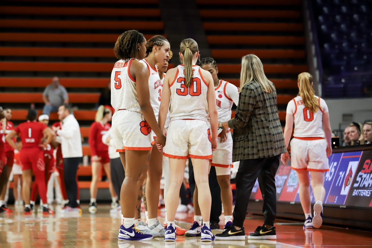 The Clemson womens basketball team meets with head coach Amanda Butler during its loss to Louisville.