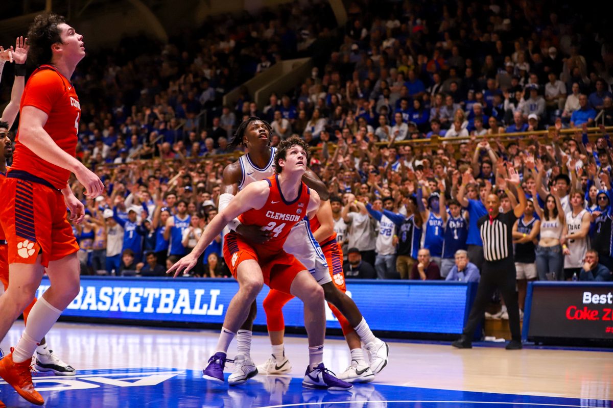 Clemsons+PJ+Hall+%2824%29+attempts+to+block+a+Duke+defender+from+grabbing+a+potential+rebound+as+fans+cheer+at+historic+Cameron+Indoor.