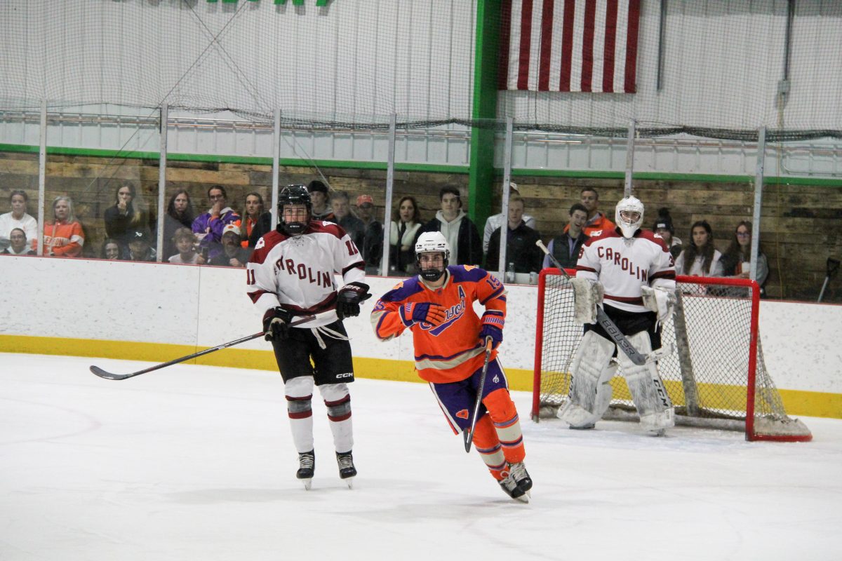 Clemson club ice hockey president Ben Brucker chases the puck toward the neutral zone during Clemsons game against South Carolina on Nov. 3, 2023.