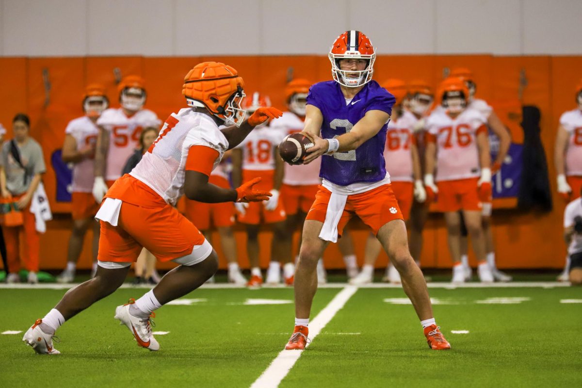 Quarterback Cade Klubnik hands the ball off to running back Phil Mafah during the first spring practice of the season for the Clemson football team on Wednesday, Feb. 28, 2024.