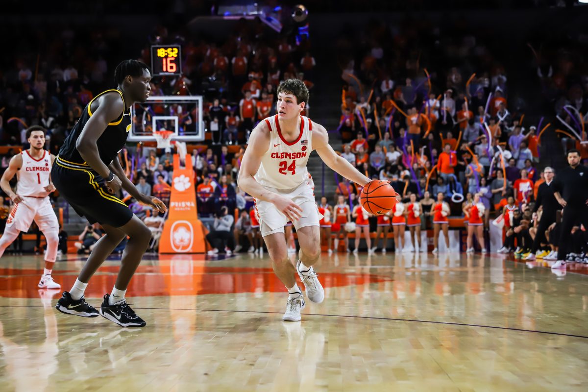 Clemson center PJ Hall (24) attempts to dribble the ball past a Pittsburgh defender in the Tigers win over the Panthers on Tuesday night at Littlejohn Coliseum. 