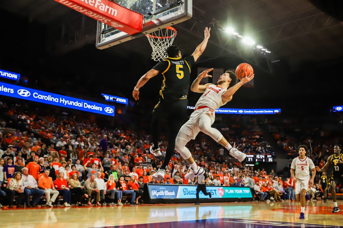 Clemson guard Chase Hunter (1) attempts a tough shot over Pittsburghs Ishmael Leggett (5) in Clemsons win over the Panthers at Littlejohn Coliseum on Tuesday night.