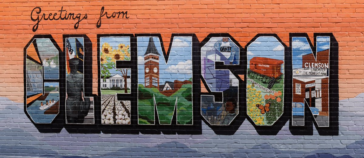 The Greetings from Clemson mural painted on the brick wall of the Tiger Sports Shop.
