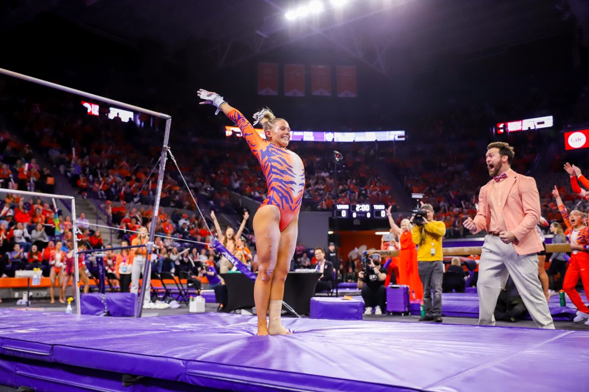 Redshirt senior Rebecca Wells has made her mark on the inaugural Clemson gymnastics team, earning career and team highs of 9.950 on floor and beam; pictured after dismounting from bars in the teams first meet against William & Mary.