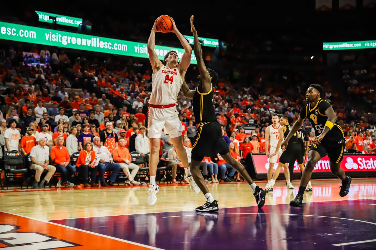 Clemson center PJ Hall (24) attempts a shot over a Pittsburgh defender in the Tigers win over the Panthers on Feb. 27 at Littlejohn Coliseum. 