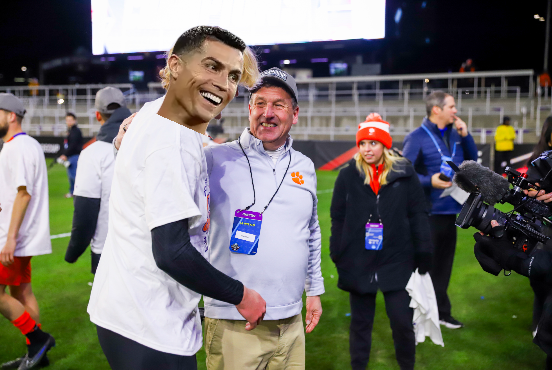 Clemson United head coach Mike Noonan is so good at his job that the big leagues are now trying to poach him; pictured at the National Championship in December talking with Cristiano Ronaldo, who flew out just to watch him coach.