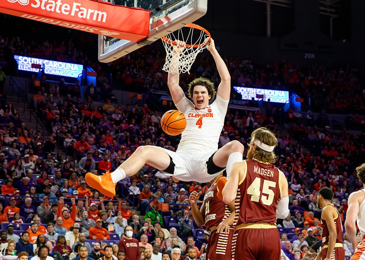 Ian Schieffelin smiles for the cameras as he dunks the ball against Boston College.
