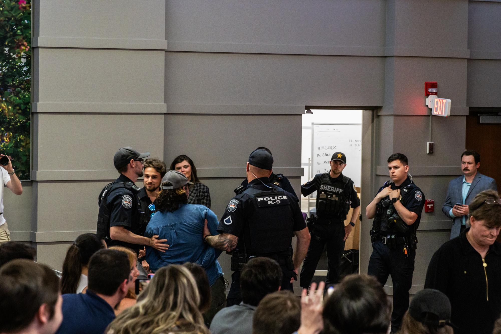 Several protesters were removed by CUPD police officers for chanting "save live, not bullets" during Clemson TPUSA's event hosting Kyle Rittenhouse.
