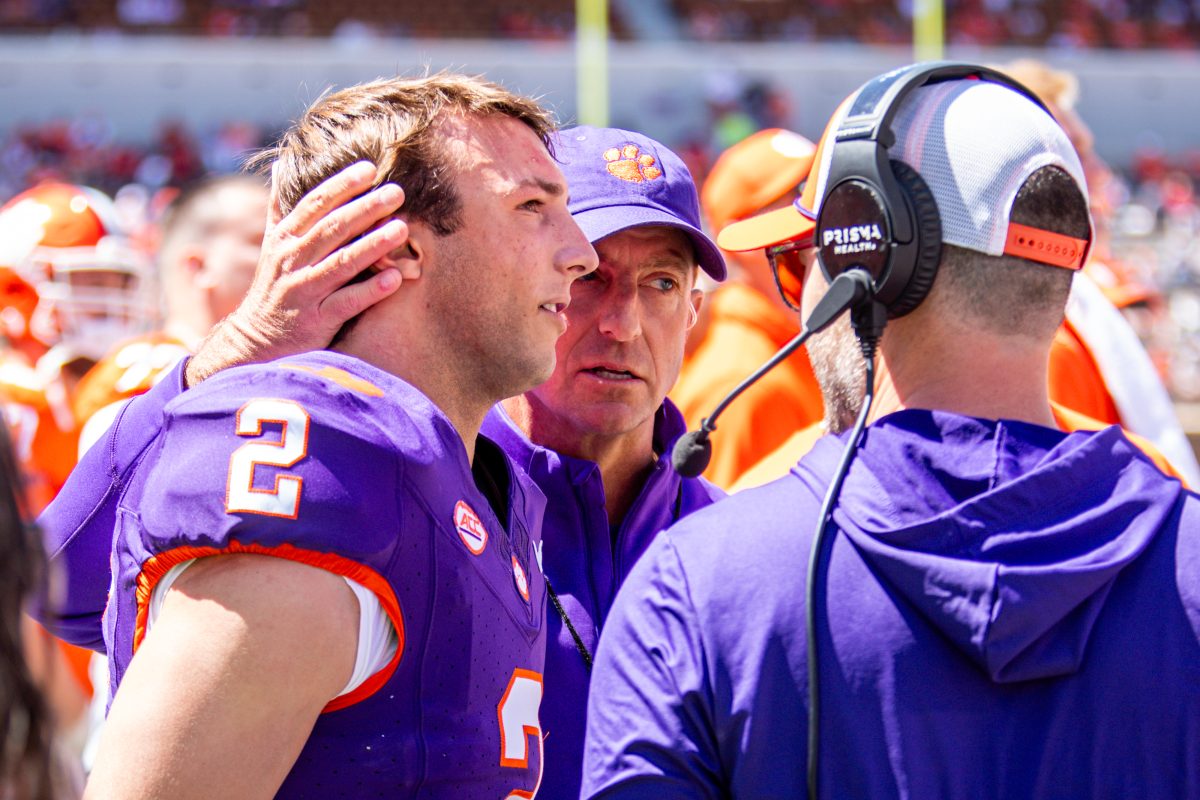 Junior Cade Klubnik, pictured talking with head coach Dabo Swinney and offensive coordinator Garrett Riley at Clemson's spring game, is preparing for his second year as a starter.