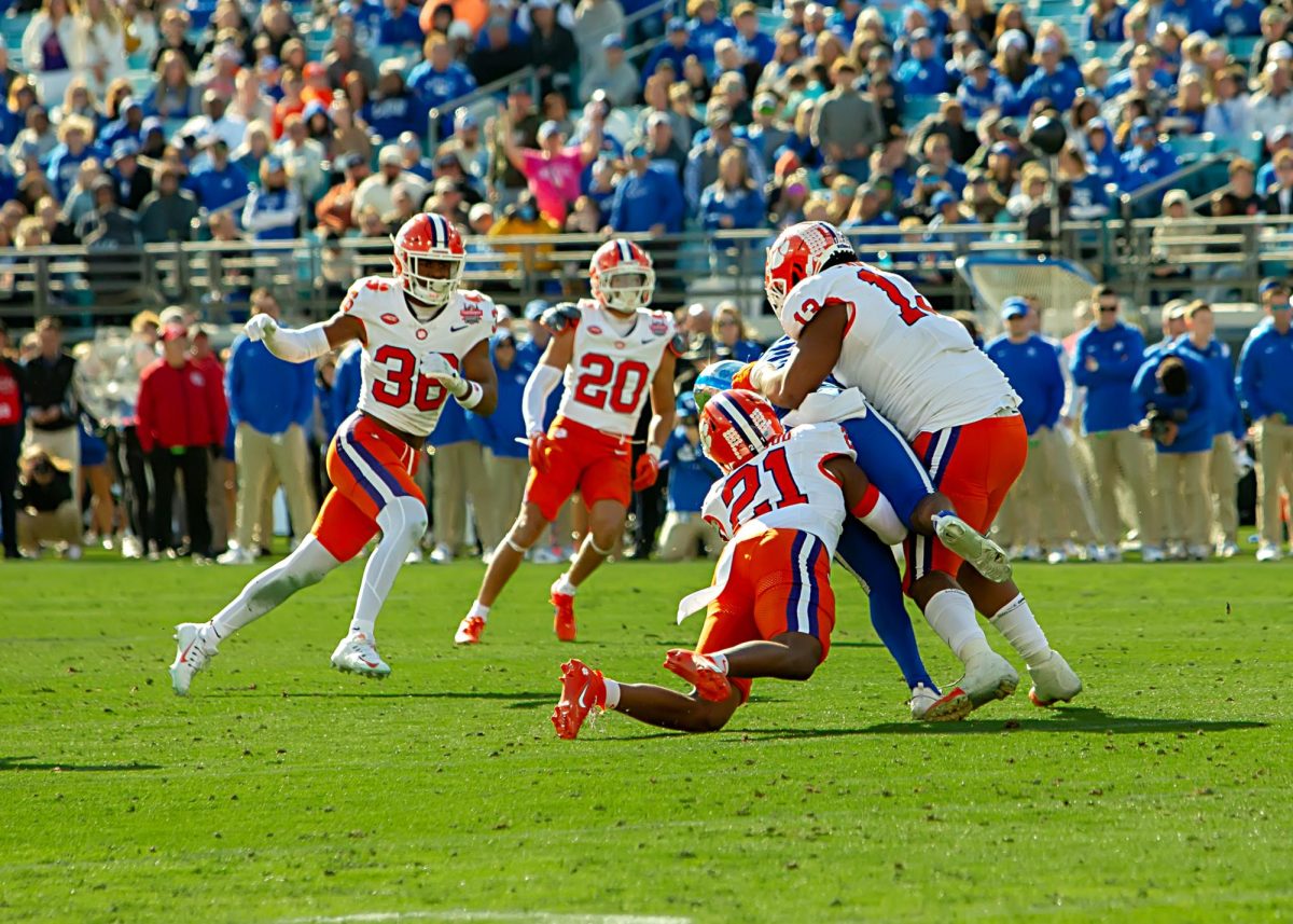 Four Clemson defenders swarm a Kentucky player in last year's 38-35 Gator Bowl victory.