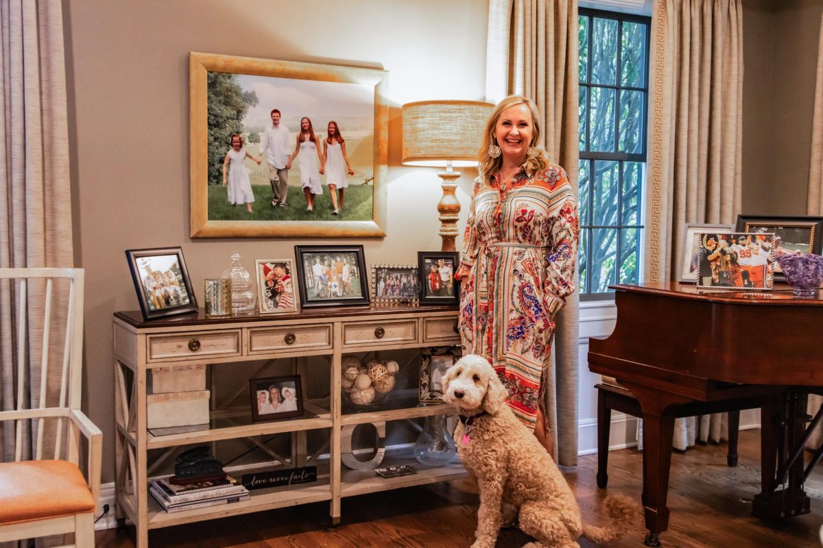 Clemson University's first lady, Beth Clements is pictured inside her on-campus home next to the family dog, Skittles.